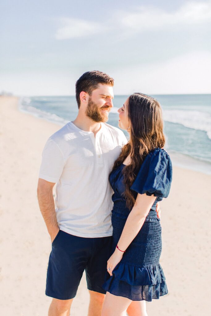 Romantic couple at the beach during sunset.