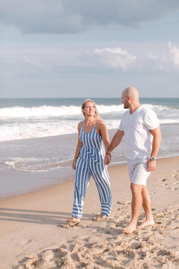 Beautiful beach engagement or couple's photos, sunset lighting, ocean backdrop.