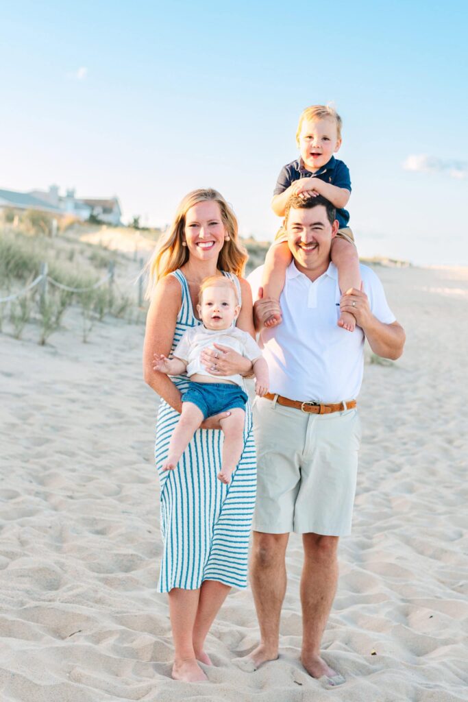 Family portrait on the beach capturing happy moments with children and parents.