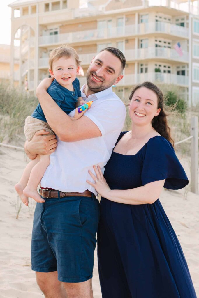 Happy family photo on the beach capturing smiles and connection.