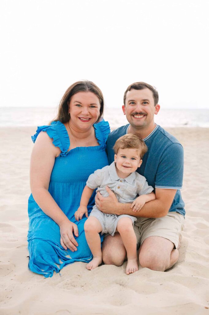Happy family portrait at the beach, capturing joy and togetherness.