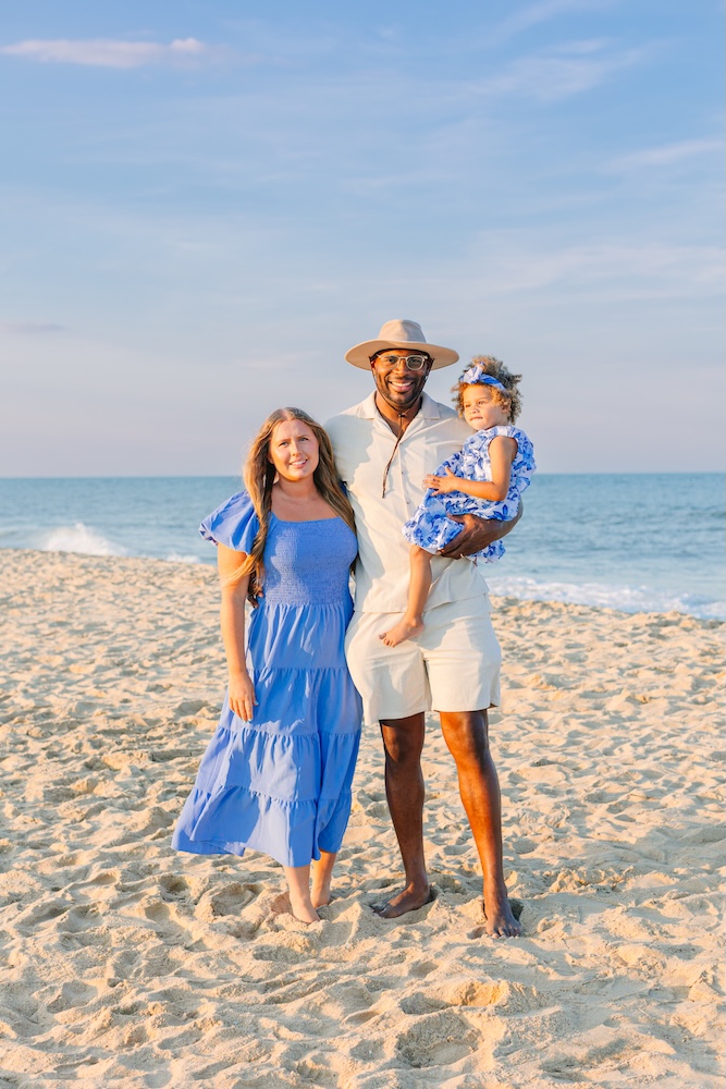 Family in coordinated blue and white outfits during golden hour beach session Fenwick Island DE